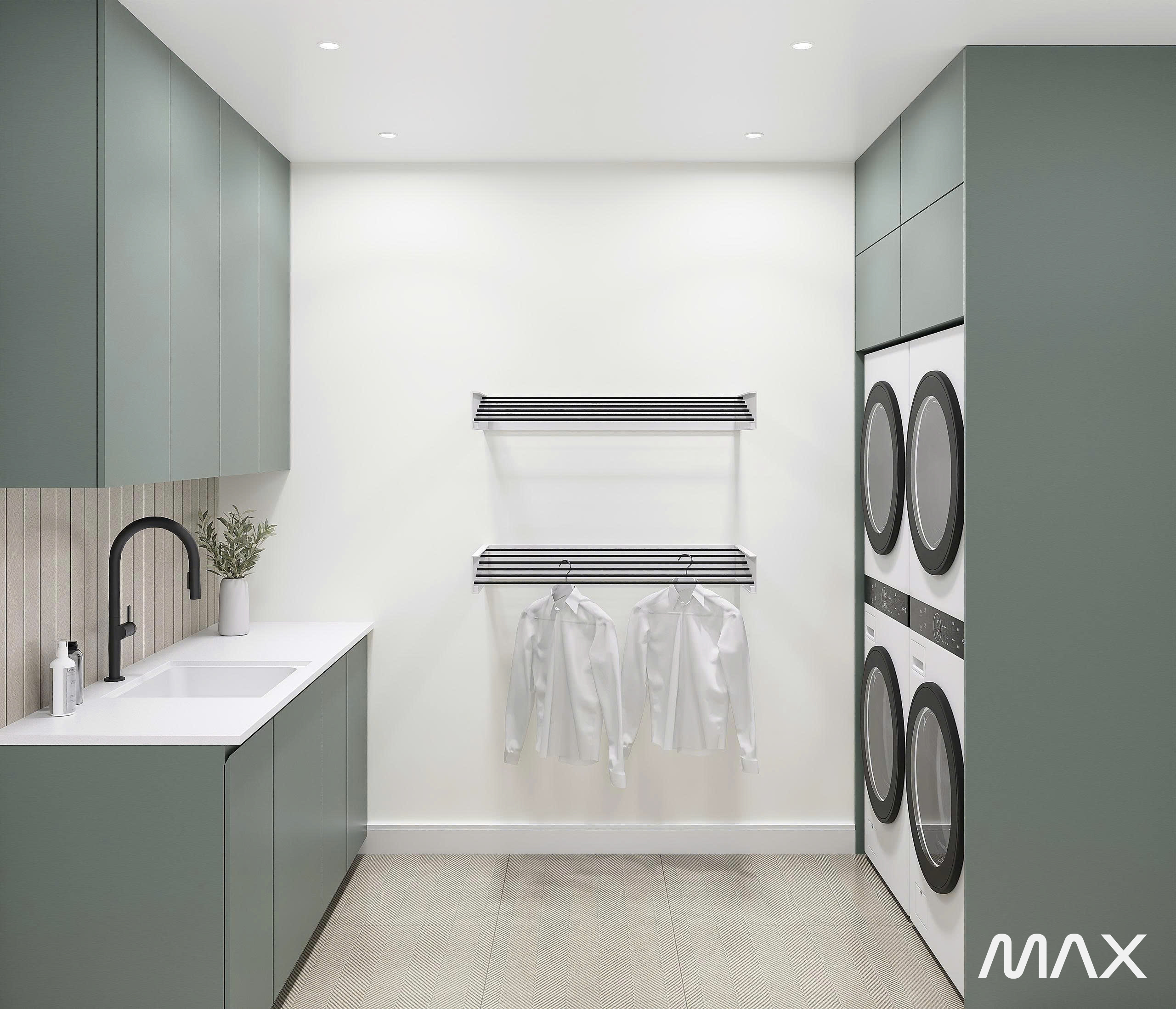 Modern laundry room with green cabinets.