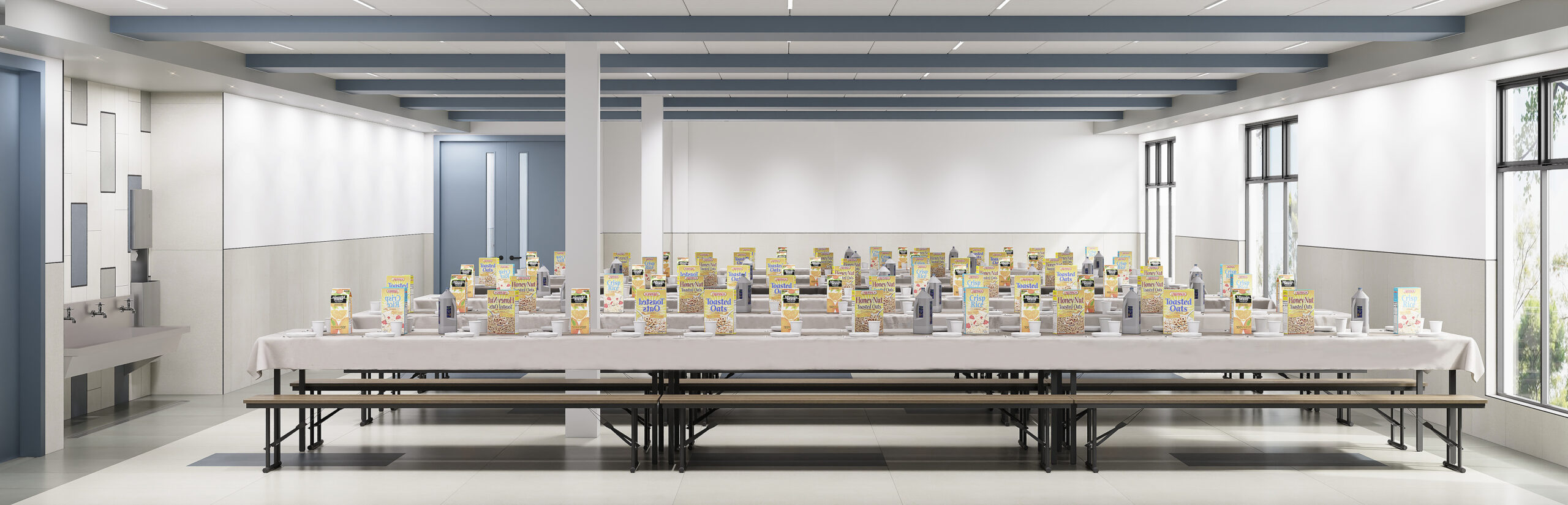 Long table with books in bright room.