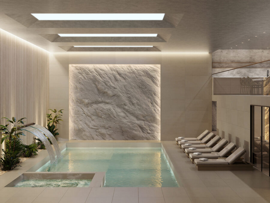 Luxurious indoor pool with lounge chairs.