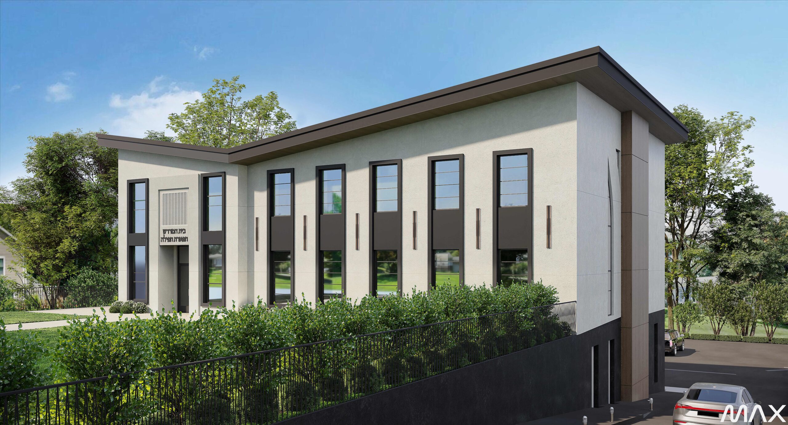 Modern building with large windows and greenery.